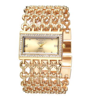 Montre de luxe dorée avec chiffres romains et cadran orné de cristaux, bracelet design unique - Milanoza